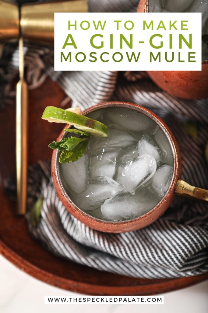 Overhead close up of a mule mug holding a Gin Gin Mule on top of a blue striped towel on a brown serving platter with text stating, "How to Make a Gin-Gin Moscow Mule"