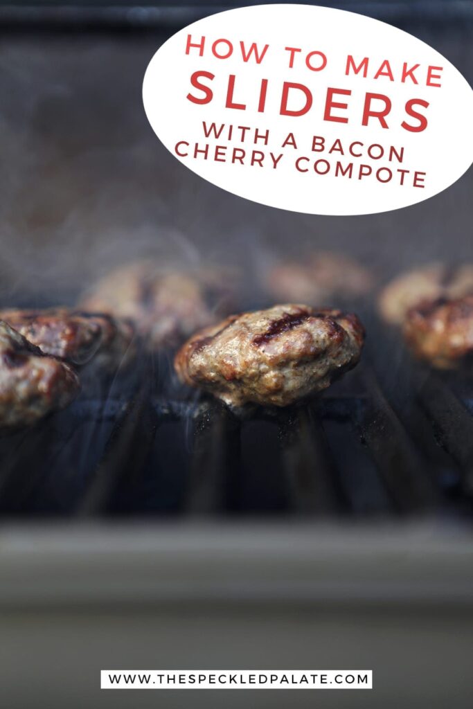 Beef sliders on a grill smoke as they finish cooking with the text "how to make sliders with a bacon cherry compote"