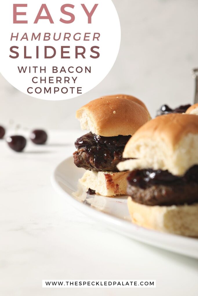 Hamburger sliders with Bacon Cherry Compote sit on a white platter before serving with text "Easy hamburger sliders with bacon cherry compote"