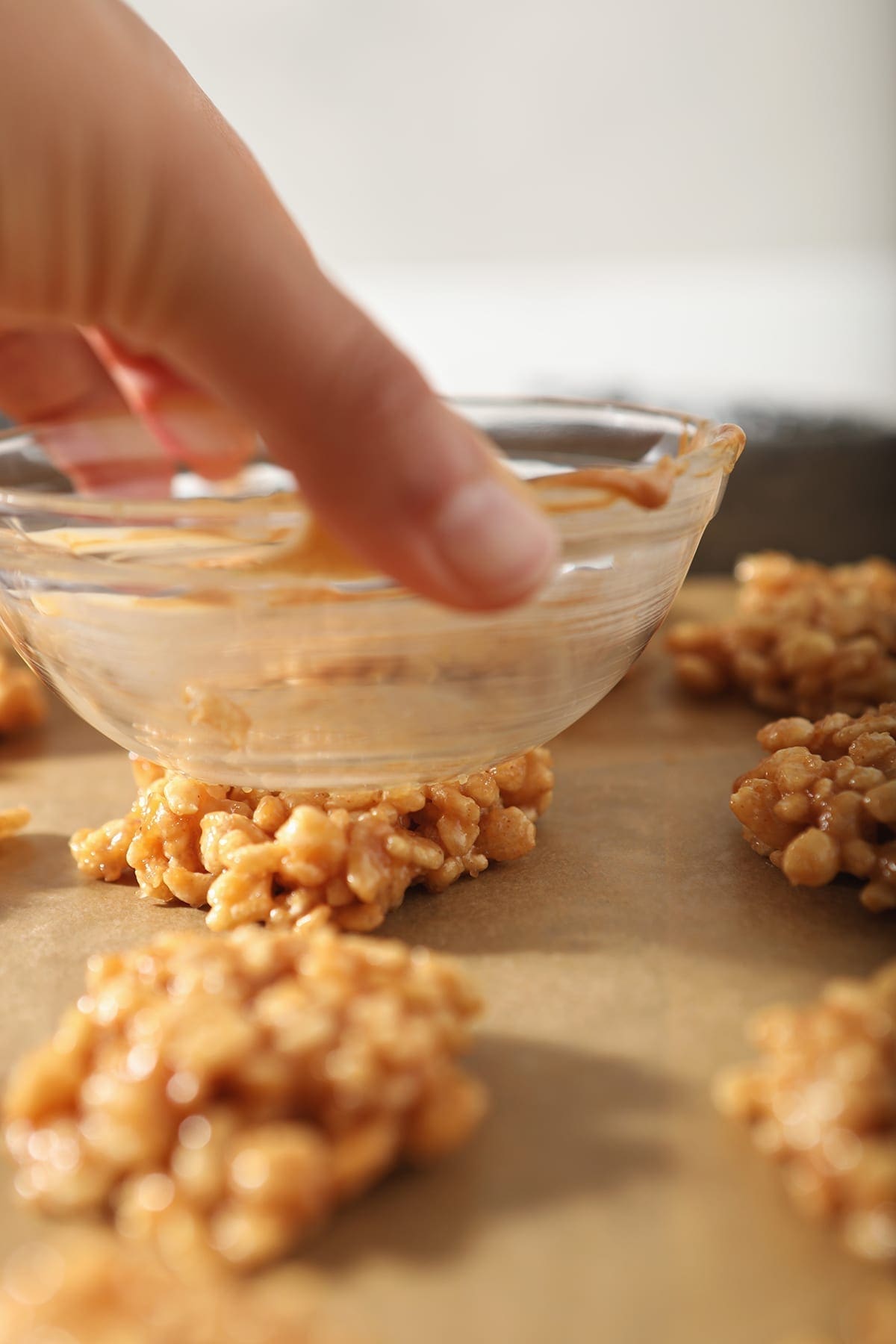 A clear glass bowl presses down on top of a no bake cookie