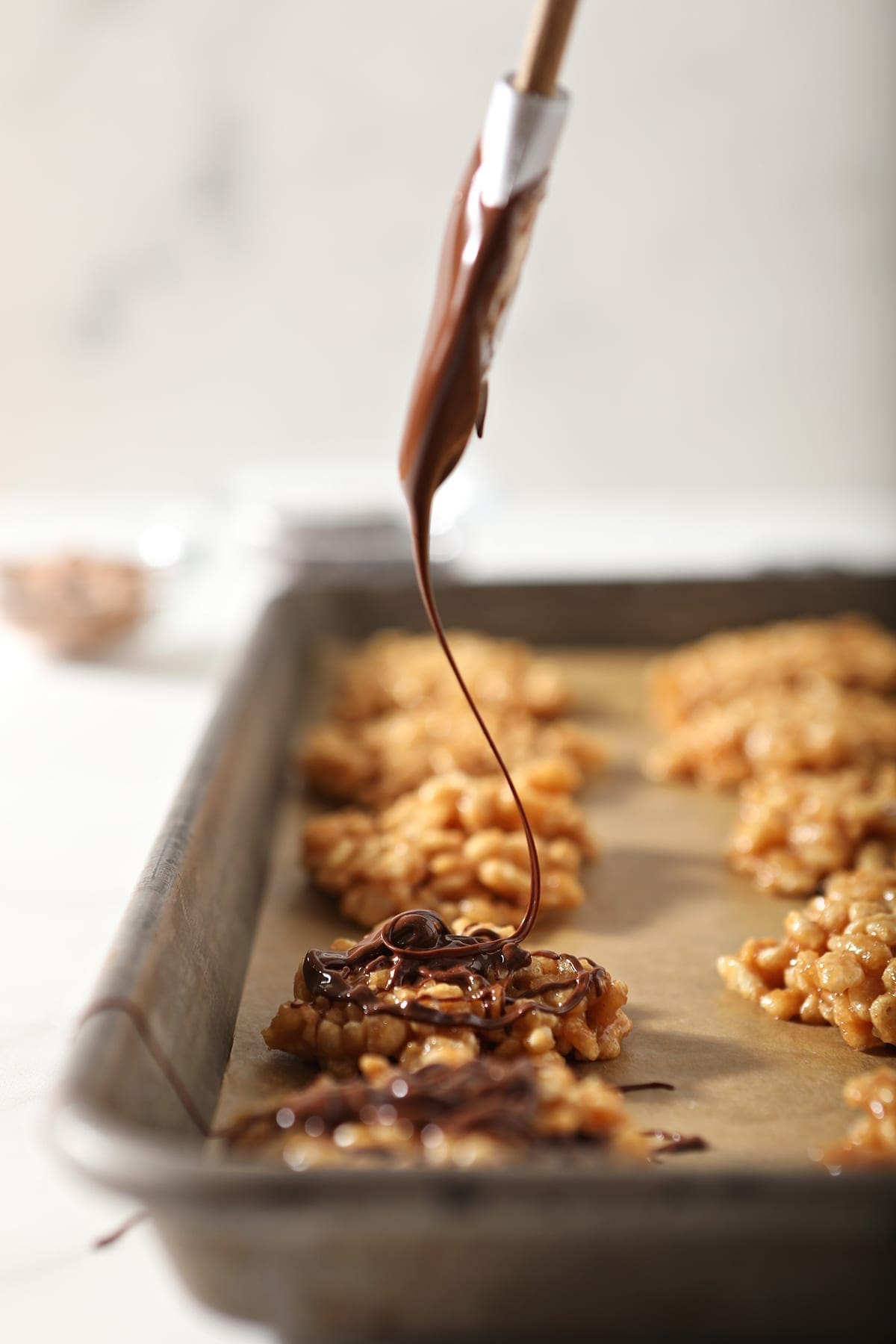 A chocolate-butterscotch mixture is drizzled on top of no bake cookies