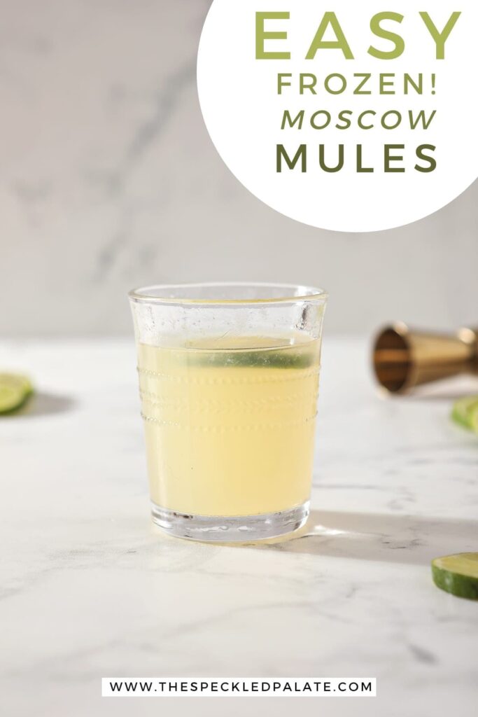 A glass of a Frozen Mule sits on a marble counter with the text "Easy Frozen! Moscow Mules"