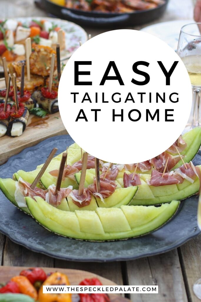 An outdoor table is laden with food and people sit around it with the text 'easy tailgating at home'