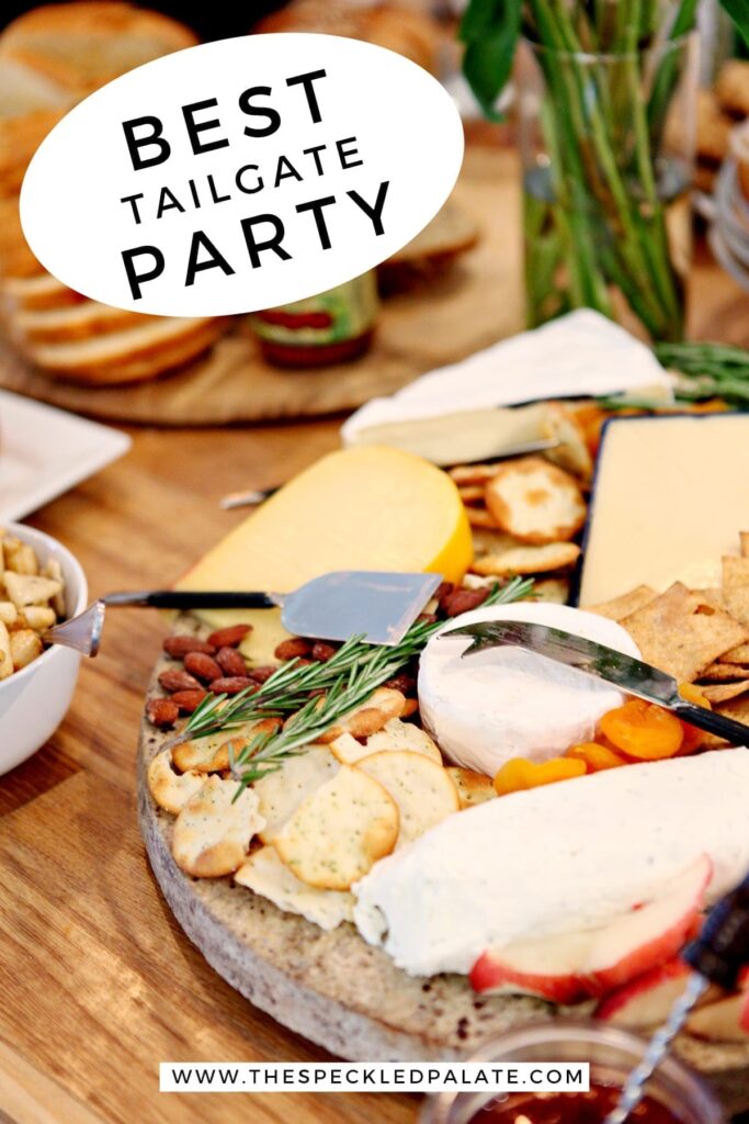 A cheese tray on a table with food at a potluck party with the text 'best tailgate party'