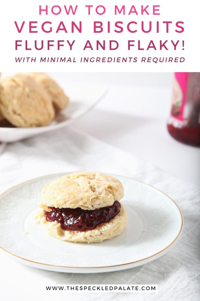 A biscuit with raspberry jam on a white plate with other biscuits and jam in the background with the text 'how to make vegan biscuits. fluffy and flaky! with minimal ingredients required.'