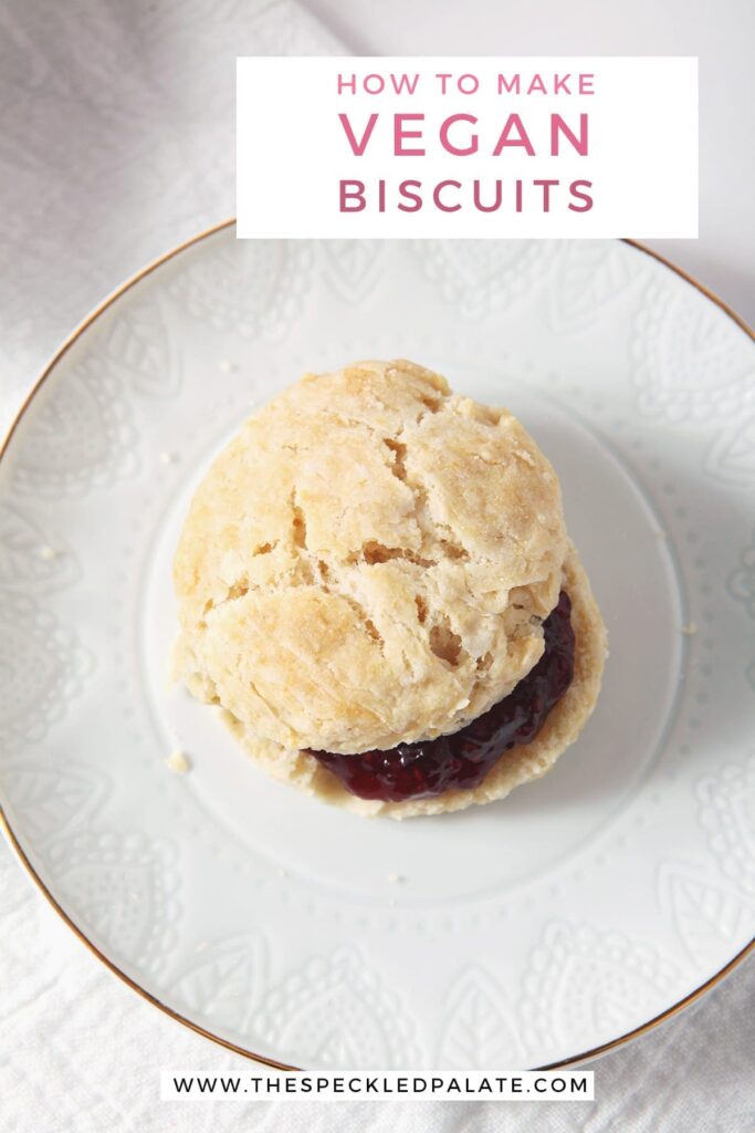 A vegan biscuit with jam on a white plate, from above, with the text 'how to make vegan biscuits'