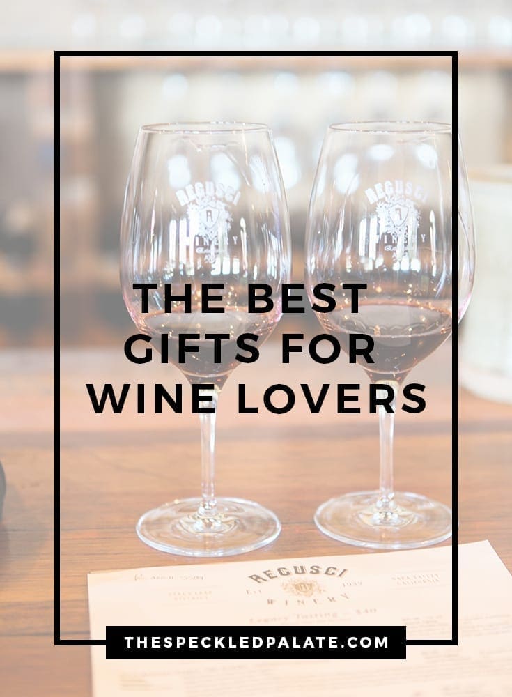 Two wine glasses on a wooden bar with the text 'the best gifts for wine lovers'