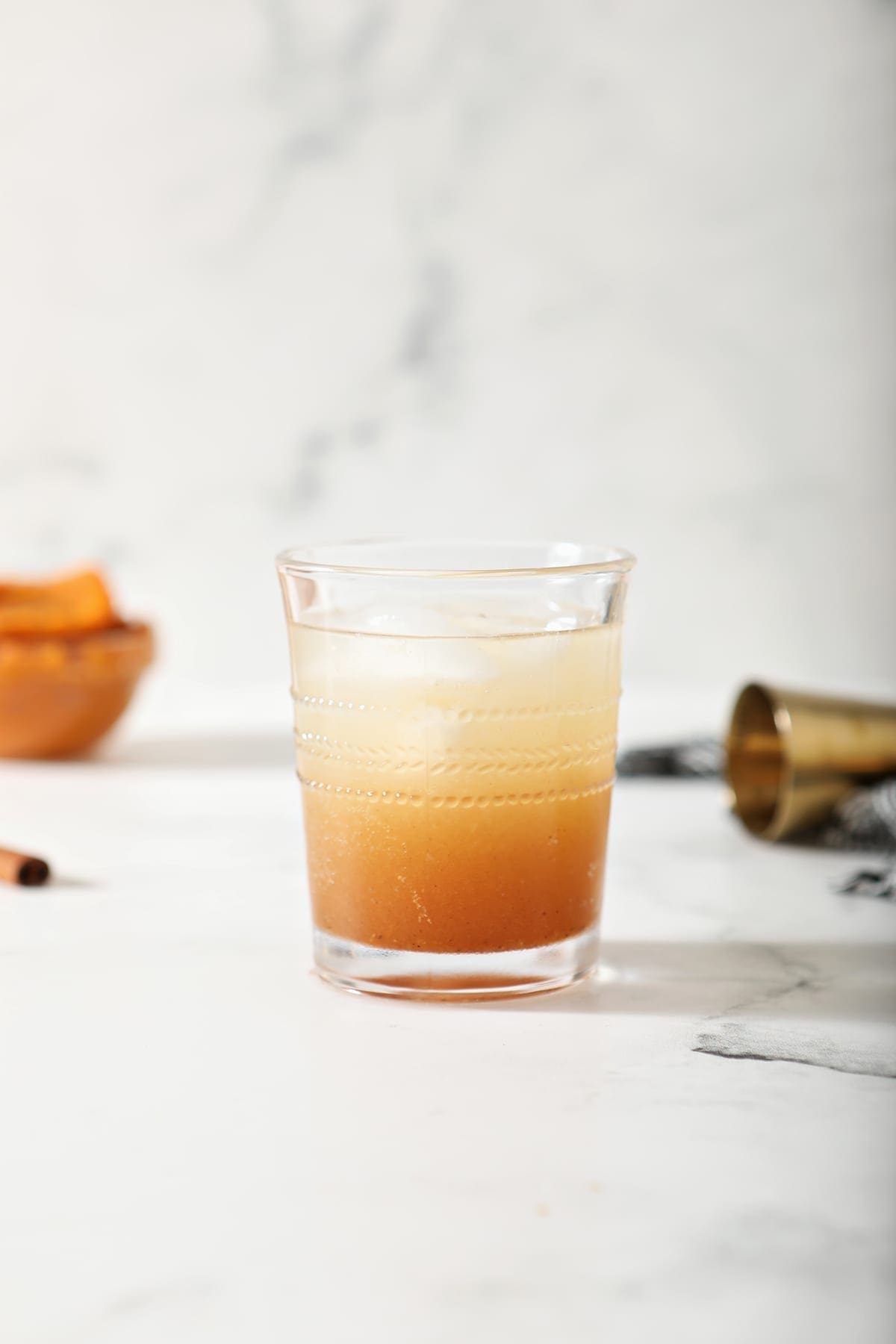 A glass of Pumpkin Spice Moscow Mule on marble, before garnishes are added