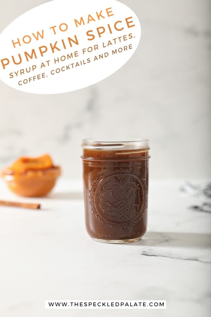 A jar of Pumpkin Spice Syrup sits on marble with a cinnamon stick and pumpkin puree behind it with the text 'how to make pumpkin spice syrup at home for lattes, coffee, cocktails and more'