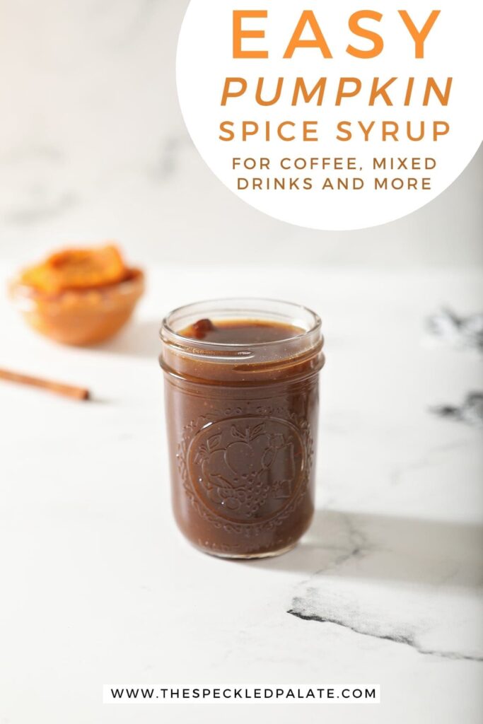 A jar of Pumpkin Spice Syrup sits on marble with a cinnamon stick and pumpkin puree behind it with the text 'easy pumpkin spice syrup for coffee, drinks and more'