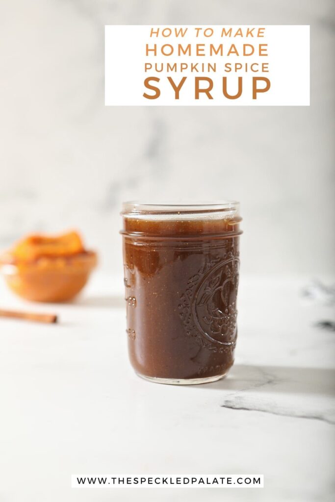 A jar of Pumpkin Spice Syrup sits on marble with a cinnamon stick and pumpkin puree behind it with the text 'how two make homemade pumpkin spice syrup'