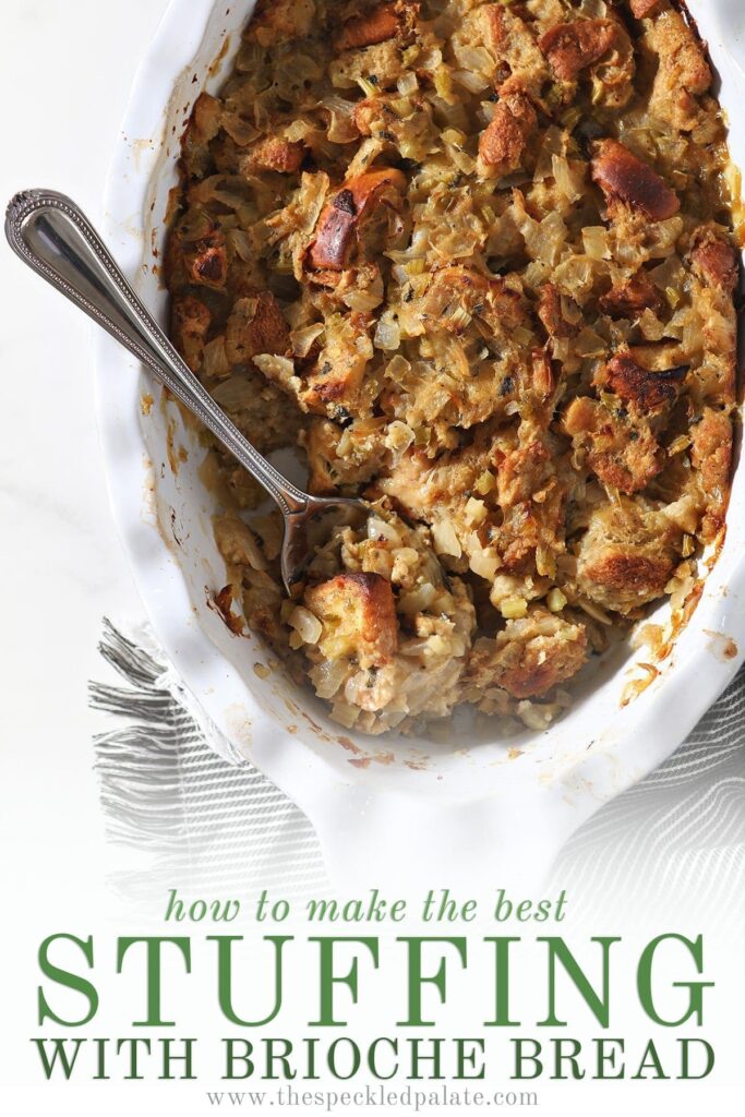 A spoon holding stuffing sits in a casserole dish holding the final baked dish with the text 'how to make the best stuffing with brioche bread'