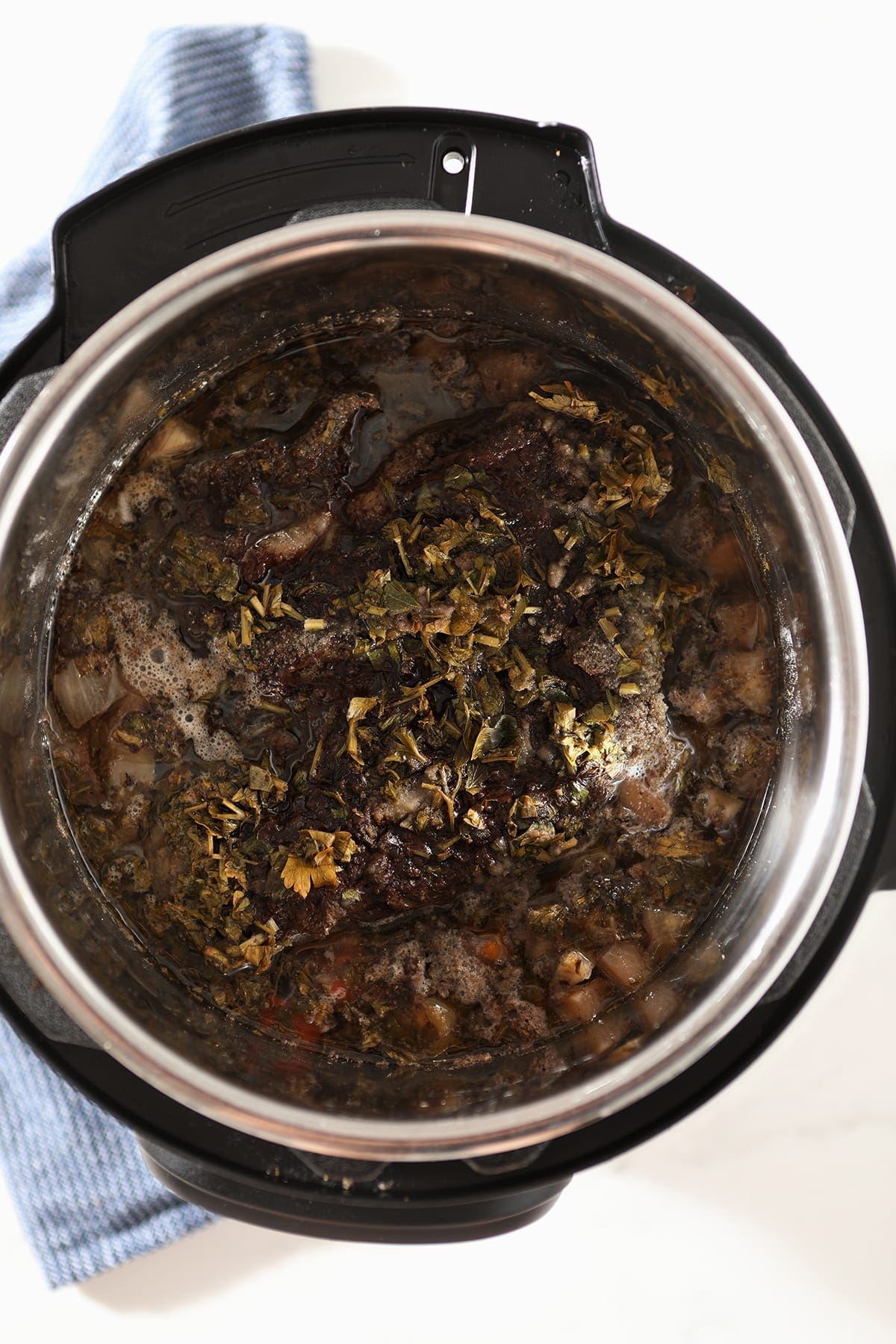 Shredded beef roast in the slow cooker after cooking