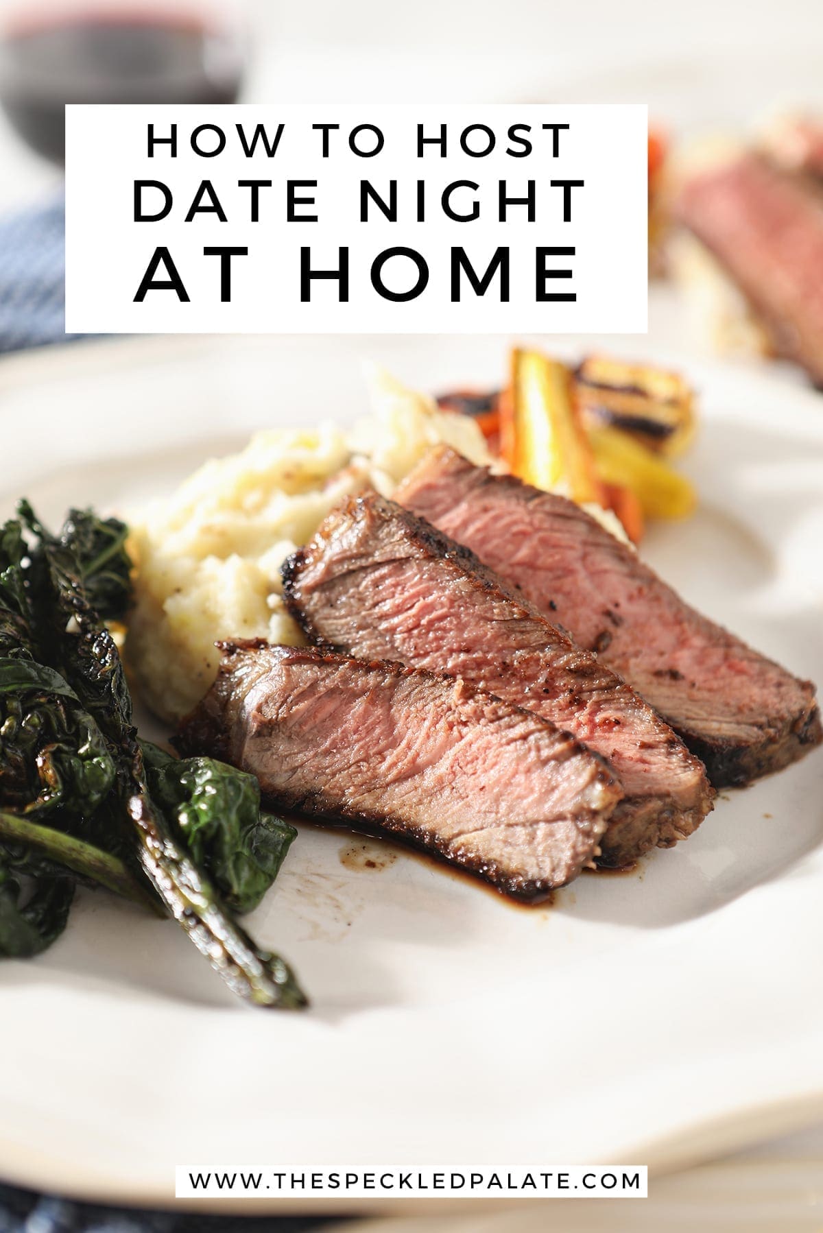 Close up of sliced ribeye on a plate with potatoes, greens and carrots with the text 'how to host date night at home'