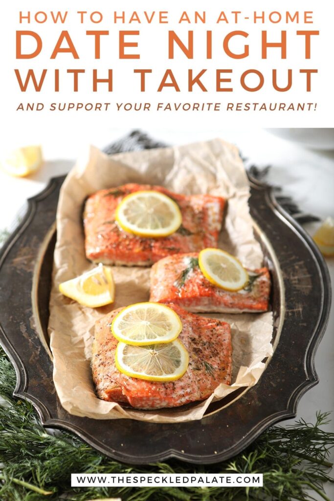 Close up of roasted salmon filets with lemon slices and thyme on them on a tarnished silver platter with the text 'how to have an at-home date night with takeout and support your favorite restaurant!'