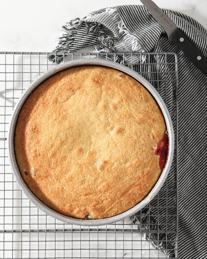The Upside Down Cranberry Cake on a wire cooling rack after baking