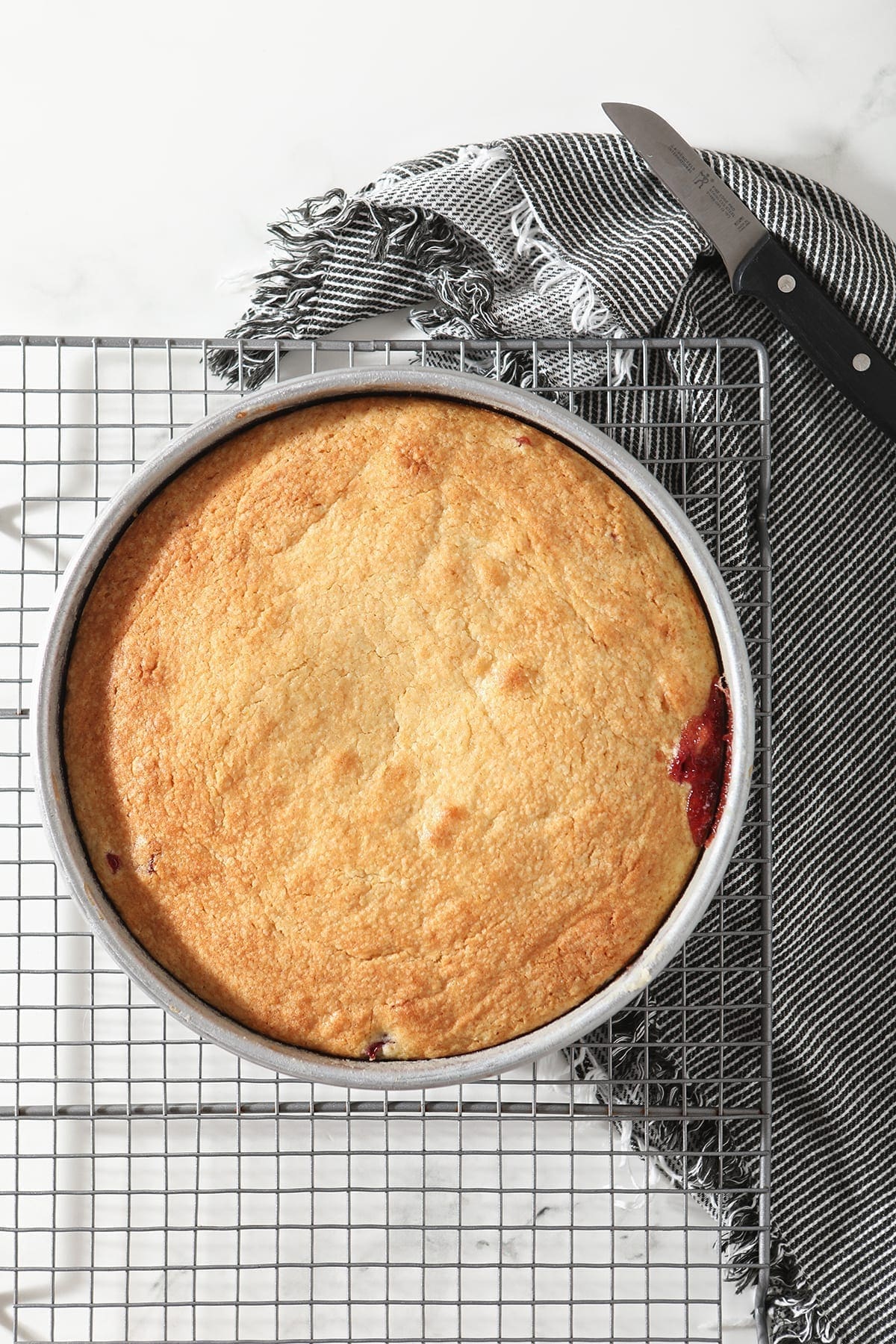 The Upside Down Cranberry Cake on a wire cooling rack after baking