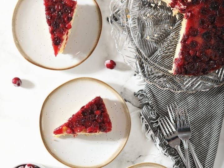 Overhead of three plates holding slices of Cranberry Cake