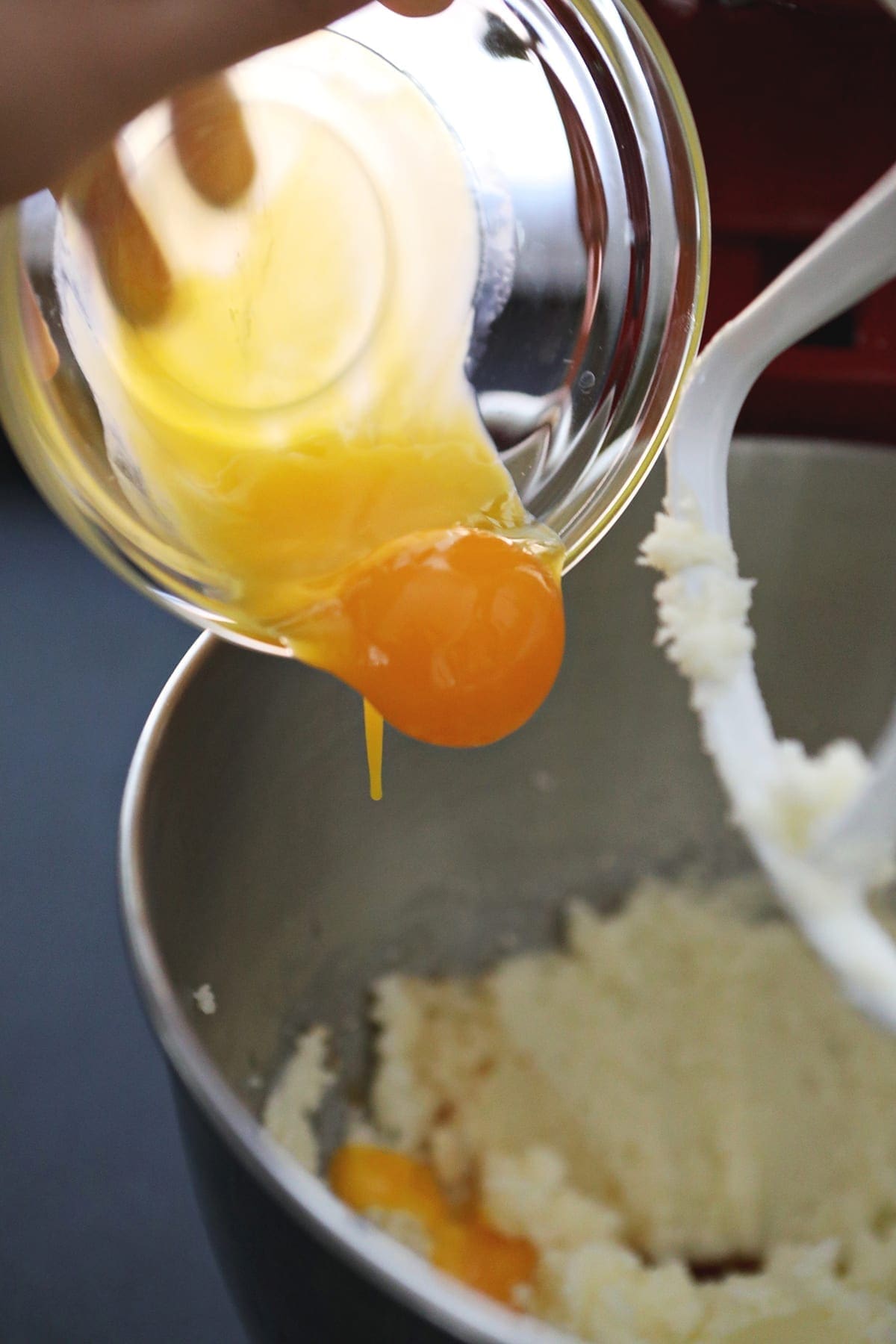 Egg yolks are dropped into a stand mixer bowl