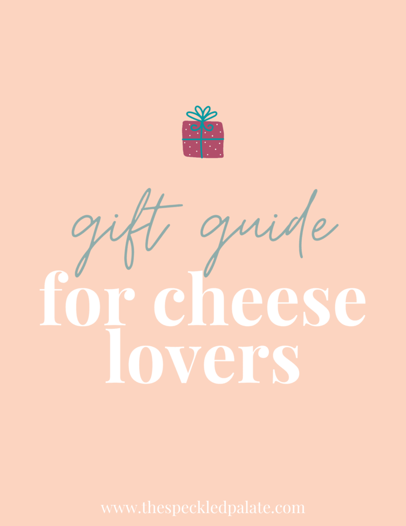 A graphic with the text 'gift guide for cheese lovers' with a colorful present on a peach background