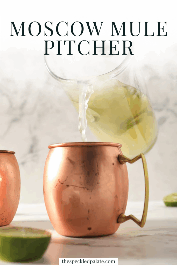 Close up of a pitcher of Moscow mule cocktail being poured in a copper mug with the text 'moscow mule pitcher'