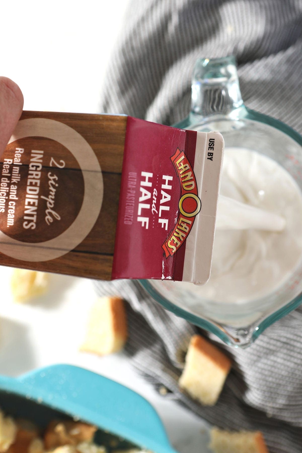 Land O' Lakes Half & Half pours into a glass measuring cup, from above