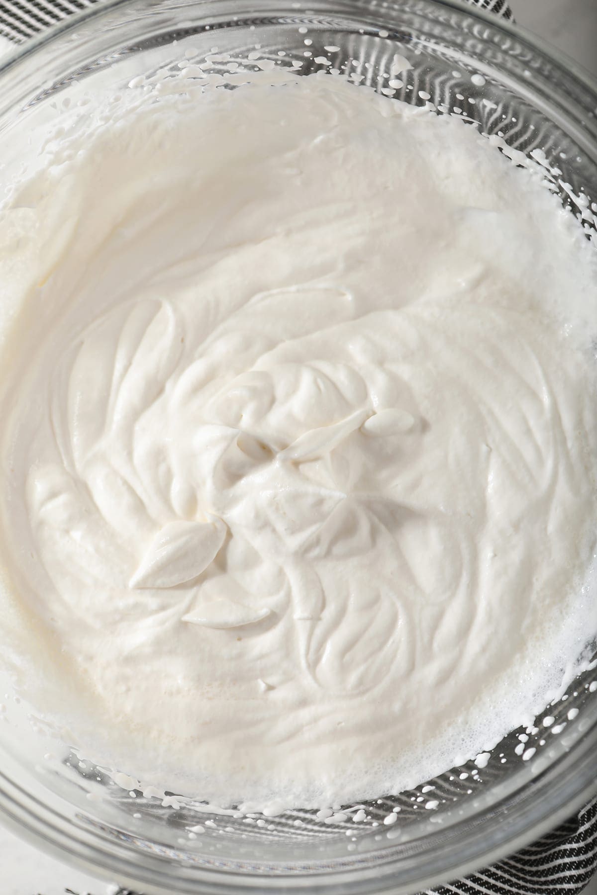 Close up of homemade whipped cream in a clear glass bowl