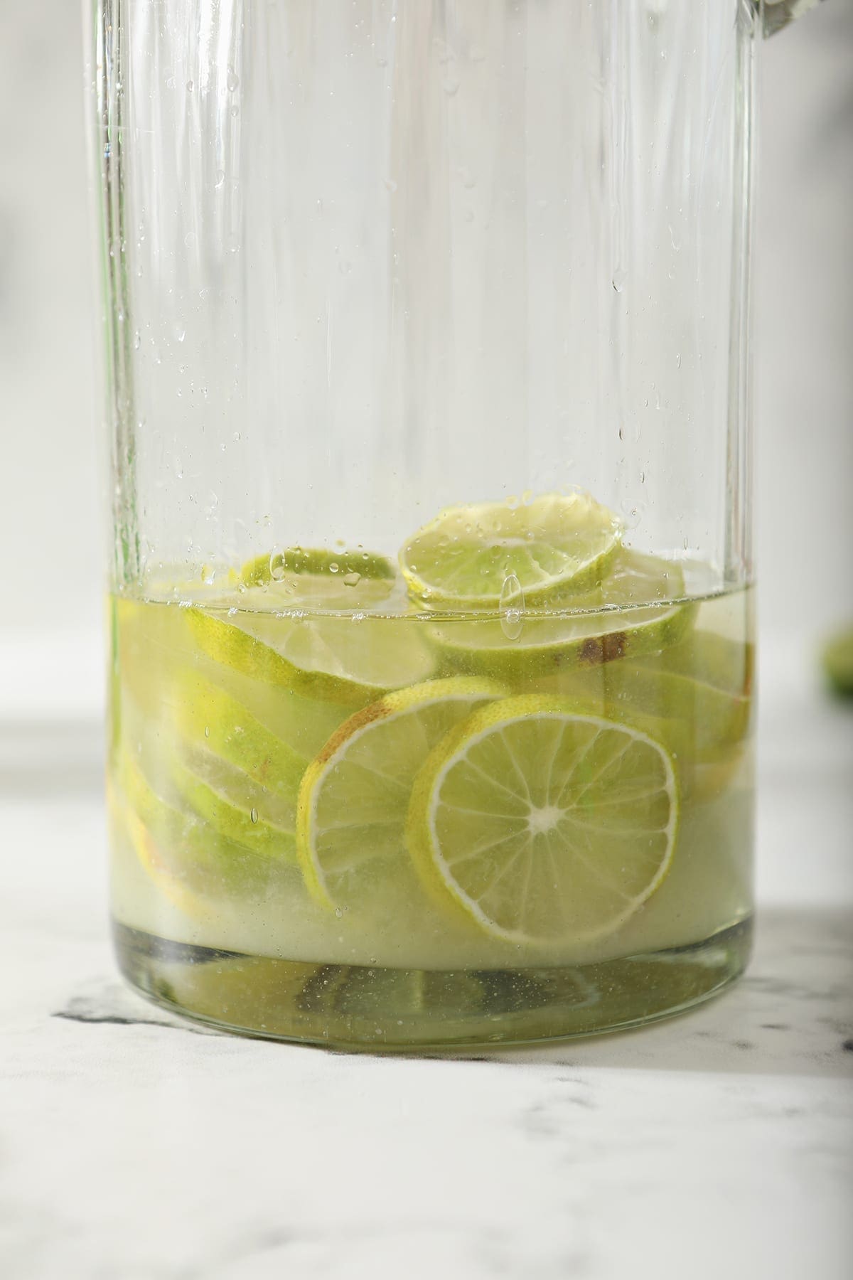 Liquid on top of lime rounds in a tall pitcher