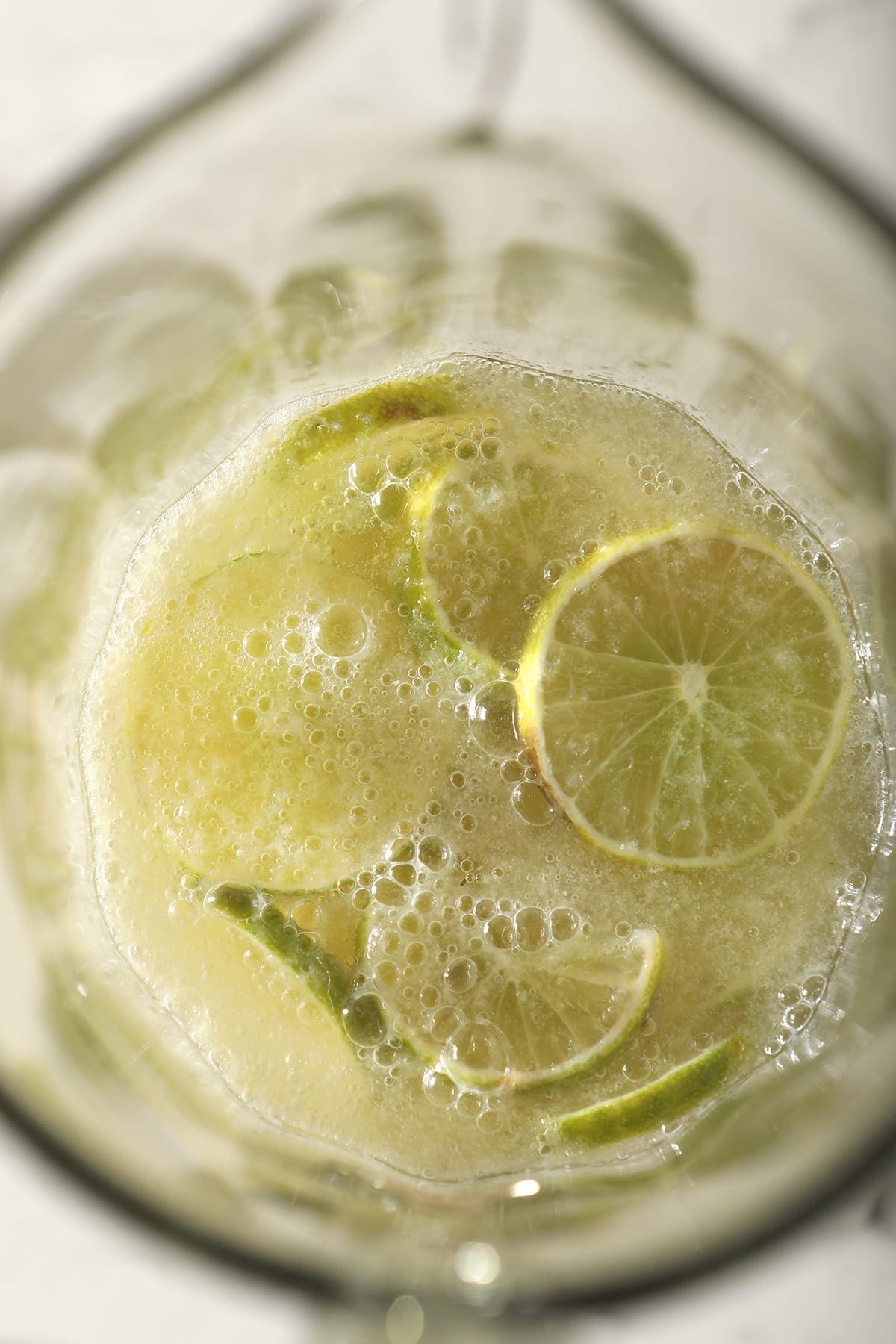 Close up of lime rounds and ingredients for a Moscow Mule pitcher