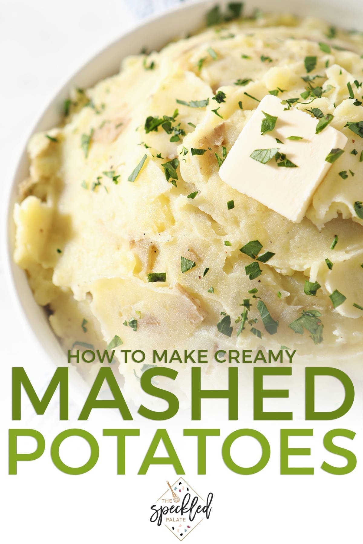 Close up of a white bowl holding mashed potatoes with a butter pat on top with the text 'how to make creamy mashed potatoes'