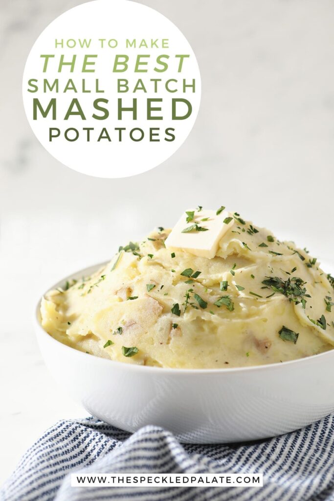 A white bowl holds a serving of creamy Homemade Mashed Potatoes while sitting on a blue and white striped towel with the text 'how to make the best small batch mashed potatoes'