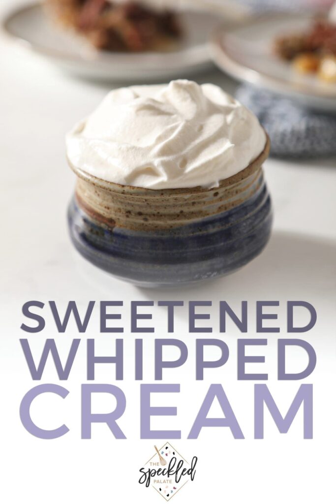 Close up of a blue pottery bowl holding a serving of homemade sweetened whipped cream with the text 'sweetened whipped cream'