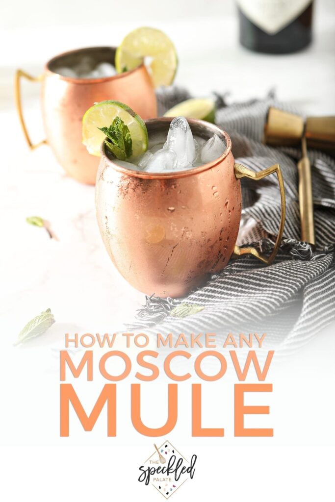 Two Gin Gin Mules in copper mugs sit on top of a gray and white striped towel next to a gold jigger with the text 'how to make any moscow mule'