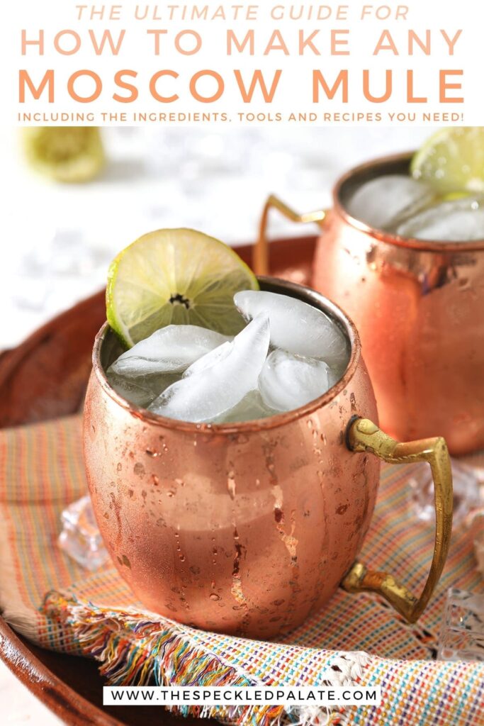 Two Mexican Mules in copper mugs on a rainbow-colored napkin with the text 'the ultimate guide for how to make any moscow mule including the ingredients, tools and recipes you need'