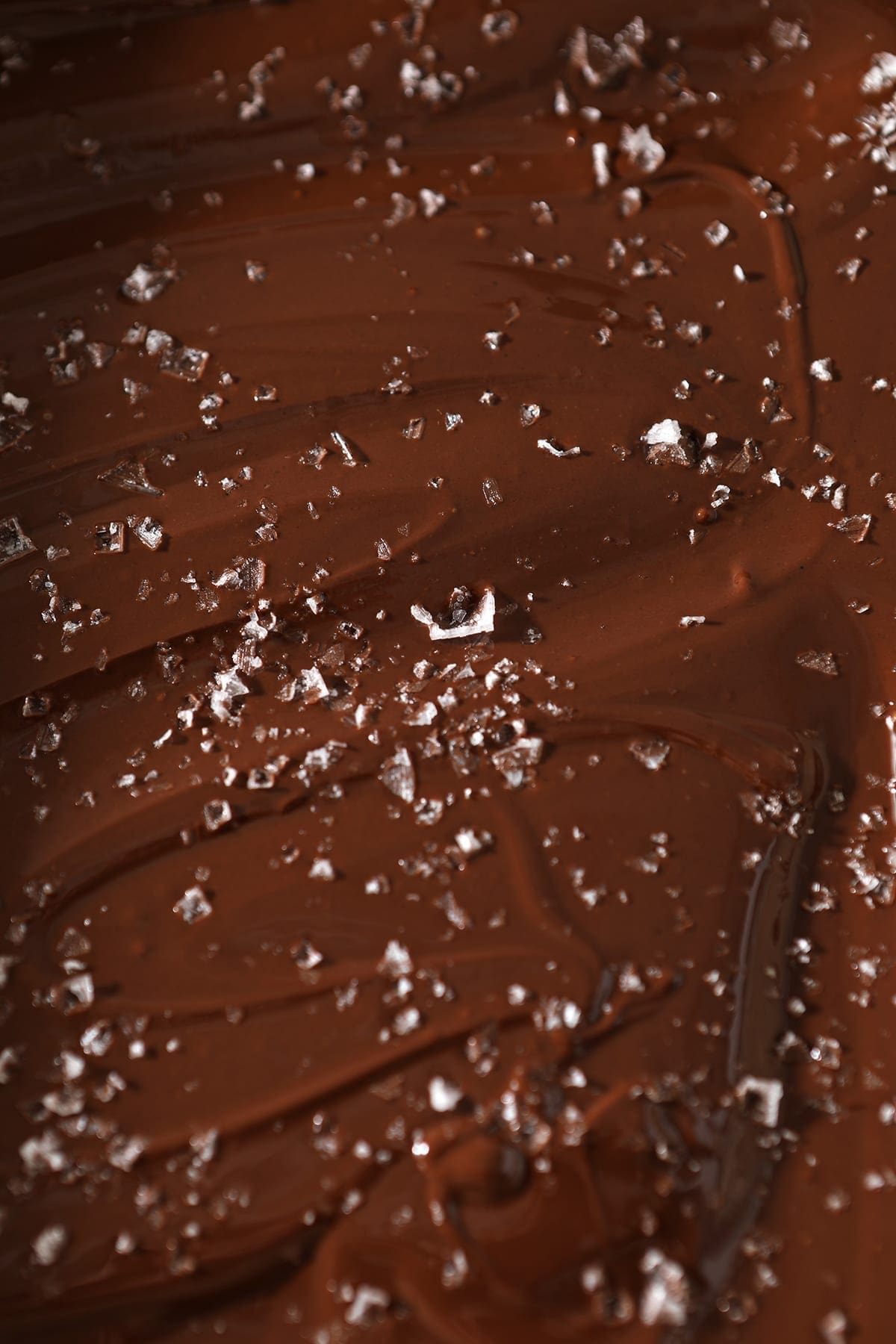 Close up of the fudge with flaky sea salt on top of it, before chilling