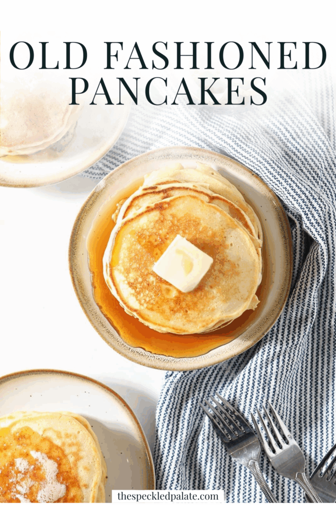 Three plates holding stacks of pancakes topped with butter sit on a blue striped towel next to forks and a container of syrup with the title "Old Fashioned Pancakes." This is a Pinterest pin.