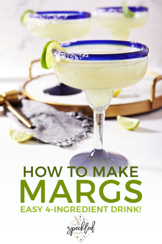 A salt-rimmed margarita sits on marble, in front of a marble tray holding two more with the text 'how to make margs. easy 4-ingredient drink!'