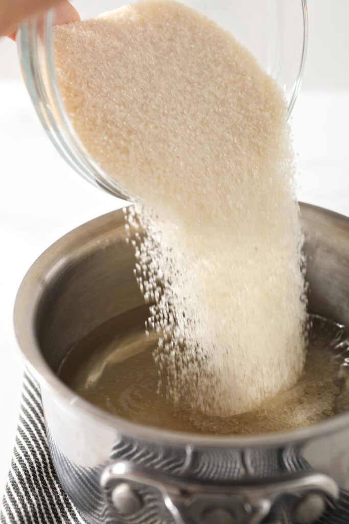 Sugar pours into a saucepan with water