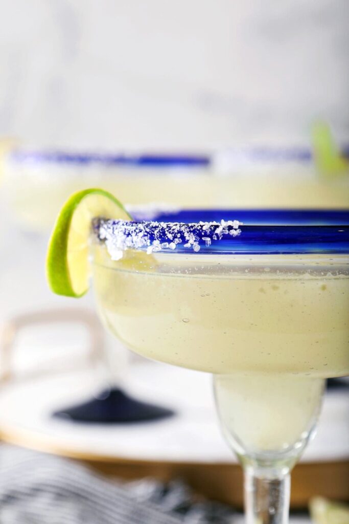 Close up of a lime twist on the salted rim of a cocktail