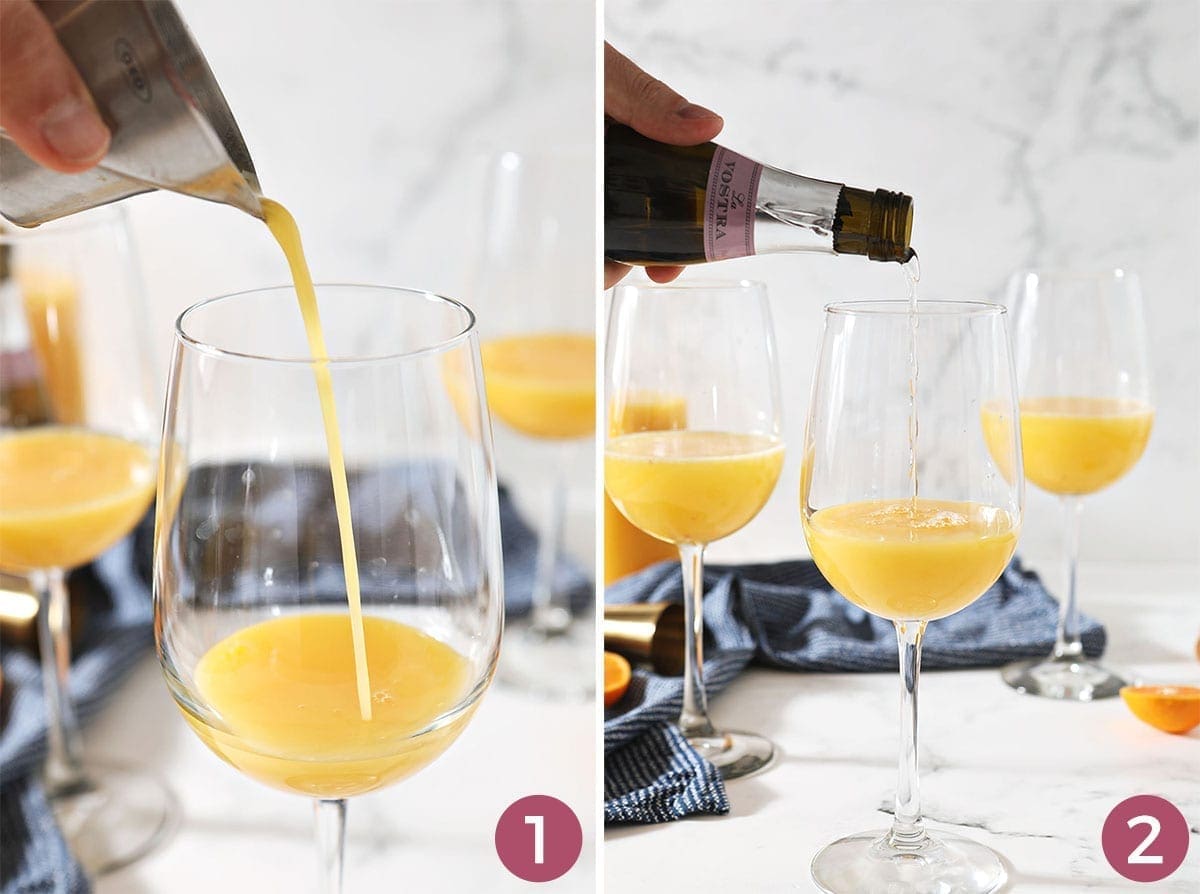 Three wine glasses holding orange drinks sit on a marble countertop