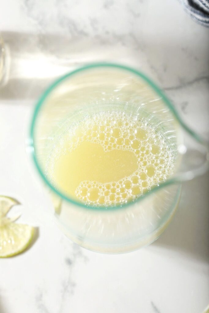 Homemade margarita mix in a glass pitcher from above