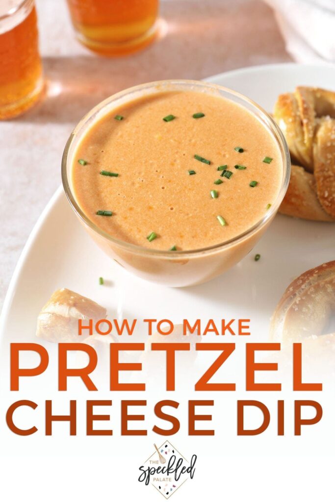 Close up of a bowl of cheese sauce on a white platter next to pretzels with the text 'how to make pretzel cheese dip'