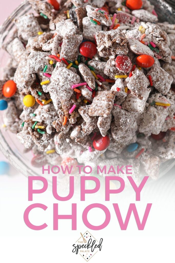 Close up of a bowl with rainbow sprinkles and chocolate-covered candies in Muddy Buddies with the text 'how to make puppy chow'