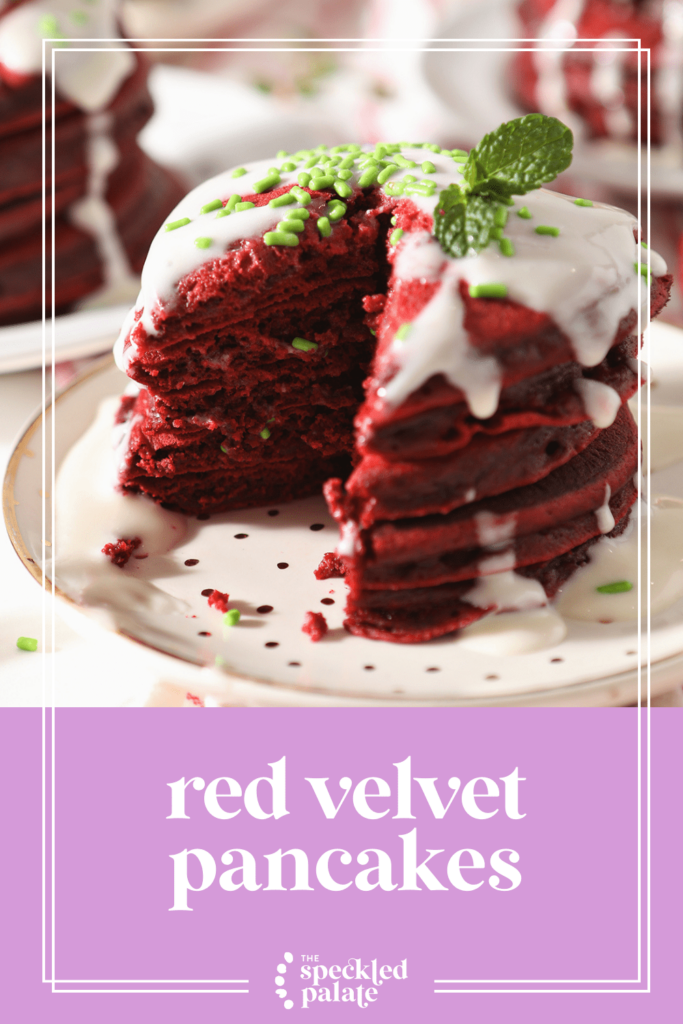 Close up of a stack of red pancakes drizzled with a cream cheese glaze with the text red velvet pancakes