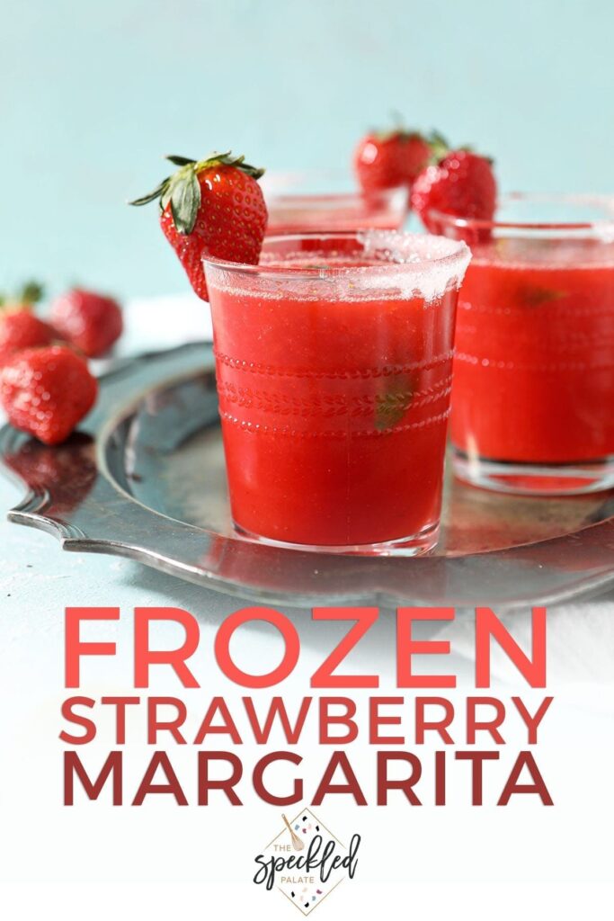 A silver tray holds three red drinks garnished with strawberries with the text 'frozen strawberry margarita'