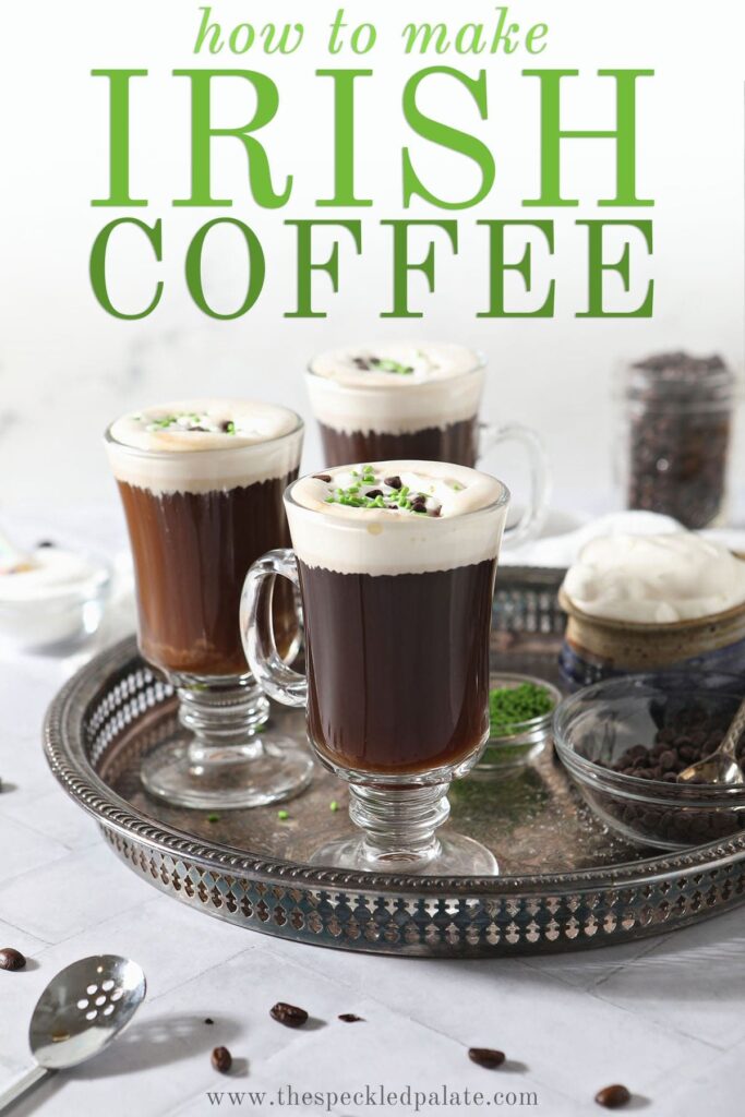 Three coffee drinks with whipped cream, chocolate and green sprinkles on a silver tray with the text 'how to make Irish coffee'