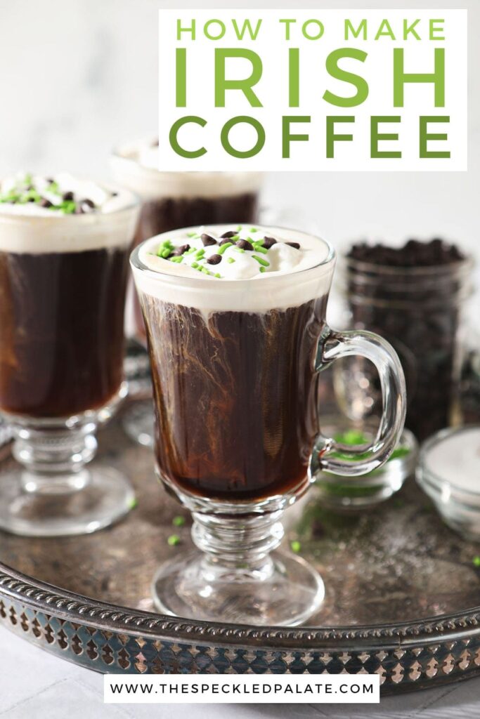 Three Irish Coffees sit on a silver tray, garnished with whipped cream, chocolate and green sprinkles with the text 'How to make Irish Coffee'