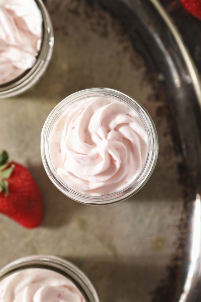 A serving of strawberry whipped cream in a glass