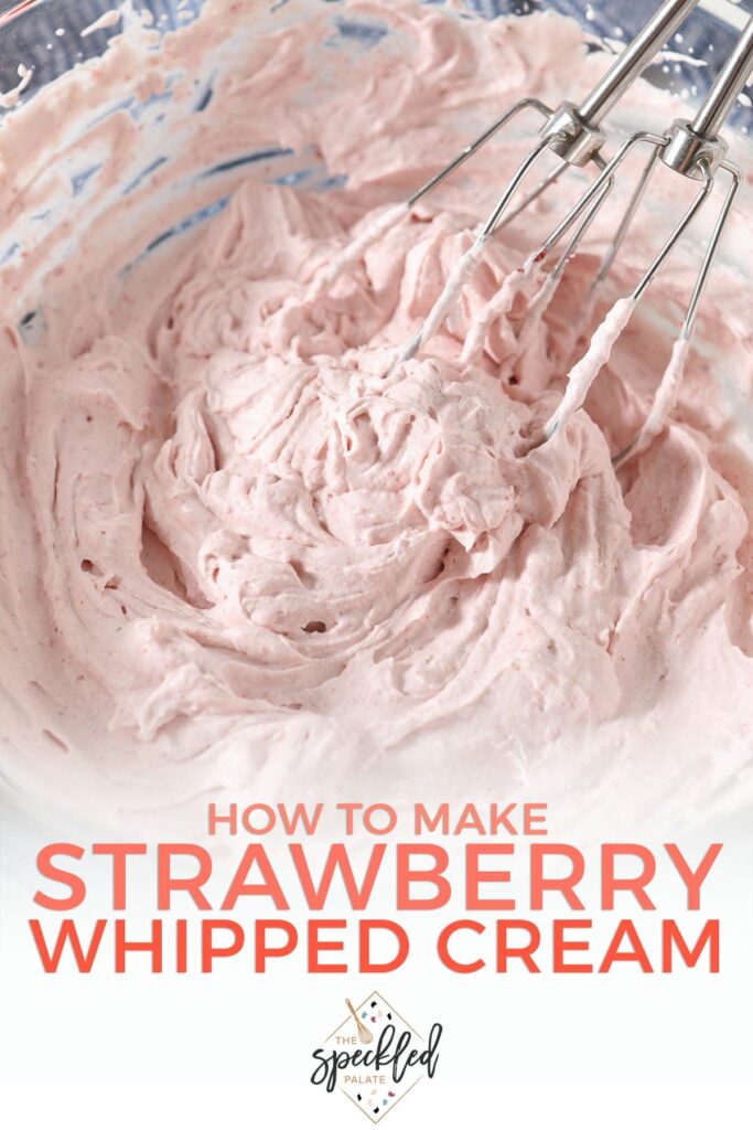 Whisks in a bowl of homemade whipped cream with the text 'how to make strawberry whipped cream'