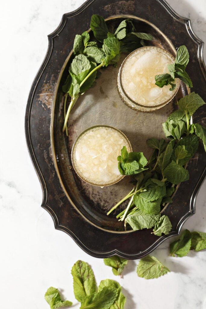 Two easy mint juleps on a silver tray with mint